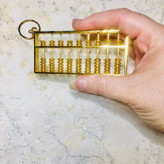 جاسوئیچی چرتکه فلزی طلایی سایز بزرگ با مهره های متحرک